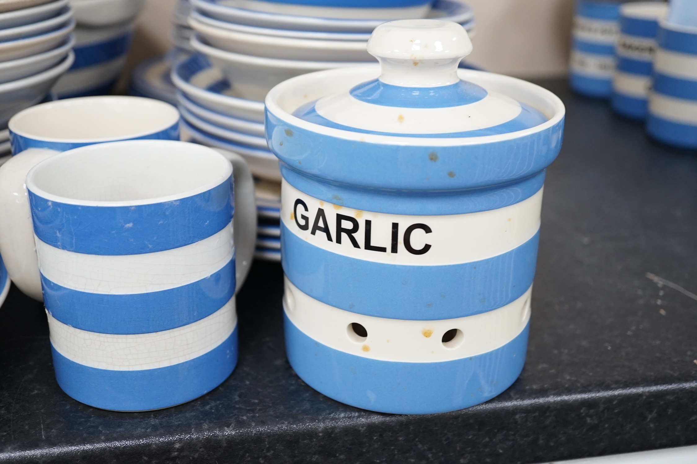 T.G.Green Cornish Kitchenware, a quantity of modern pieces to include a Garlic jar and cover, commemorative cups, mugs, bowls, dishes, etc., approximately sixty five pieces. Condition - fair to good